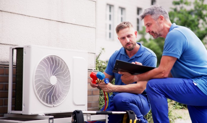 HVAC technicians installing an outdoor air conditioning unit in Chandler
