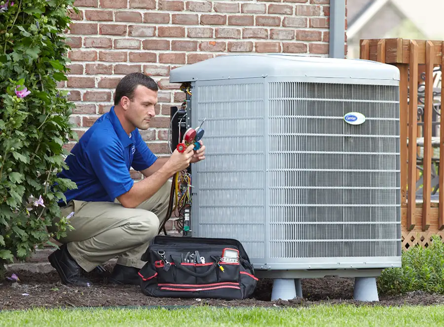 HVAC technician inspecting an outdoor air conditioning unit in Chandler